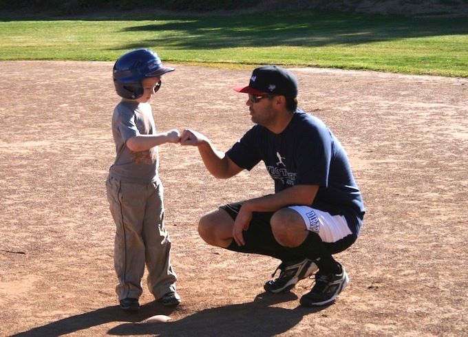 baseball little league coach with player