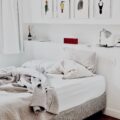 White bedroom with art over the bed